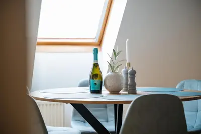 a bottle of wine sitting on a table at Sky Loft near Center 220m, AC, PS5, Free Parking in Prague