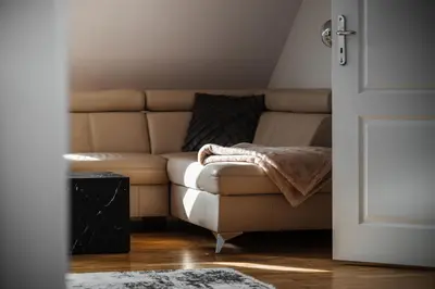 a living room with a couch and a table at Sky Loft near Center 220m, AC, PS5, Free Parking in Prague