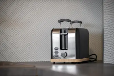 a black and silver toaster sitting on a table at Sky Loft near Center 220m, AC, PS5, Free Parking in Prague
