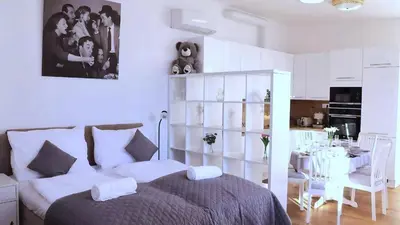 a bedroom with a bed and a dining room at Bright Apartment near Main Station in Prague