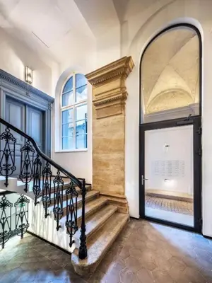 a hallway with a staircase and a door with a window at Bright Apartment near Main Station in Prague
