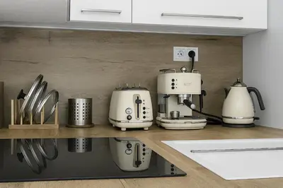 a kitchen with several appliances on a shelf at Bright Apartment near Main Station in Prague
