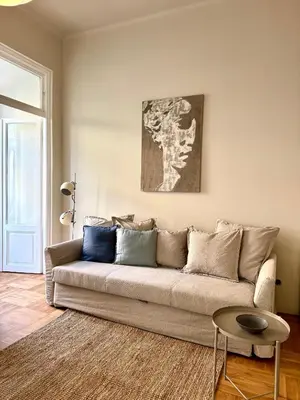 a living room with a couch and a table at Elegant,Bright,Best location in Prague