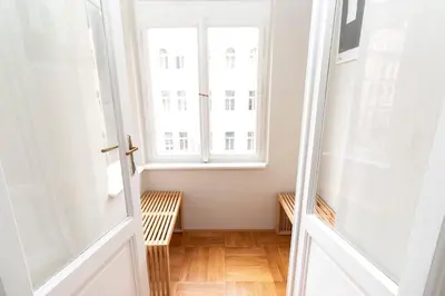 an empty room with a window and wooden floors at Elegant,Bright,Best location in Prague