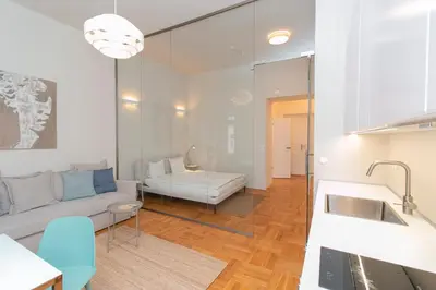 a living room with a couch and a table at Elegant,Bright,Best location in Prague