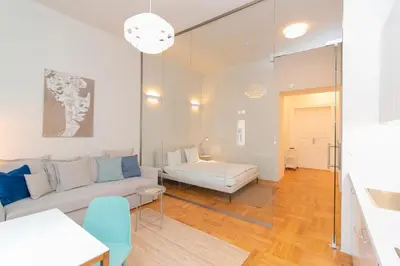 a living room with a couch and a table at Elegant,Bright,Best location in Prague