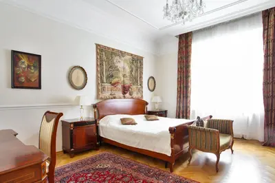 a bedroom with a bed and a table and chairs at Prague Imperial Heritage in Prague