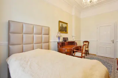 a bedroom with a bed and a desk and a chair at Prague Imperial Heritage in Prague