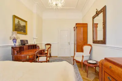 a bedroom with a desk and a table with a mirror at Prague Imperial Heritage in Prague