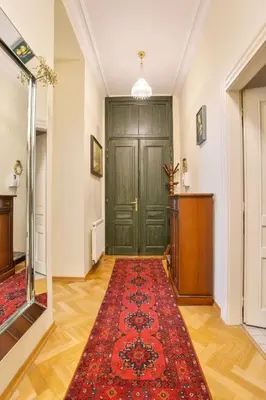 a hallway with a green door and a red rug at Prague Imperial Heritage in Prague