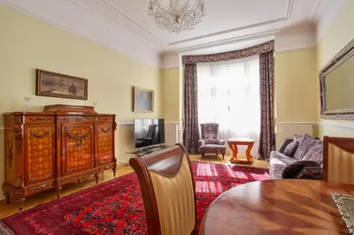 a living room with a dining table and a television at Prague Imperial Heritage in Prague