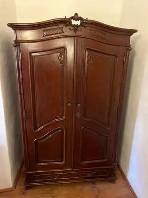 a wooden cabinet in the corner of a room at Artillery Barracks Accommodation in Terezín