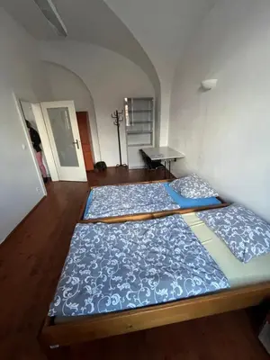a bedroom with two beds in a room at Artillery Barracks Accommodation in Terezín