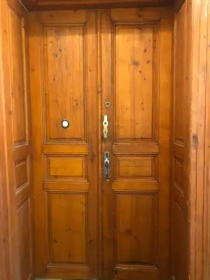 a pair of wooden doors in a room at Central cozy rooms Soukenická S34 in Prague