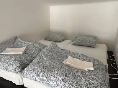 two twin beds with pillows on them in a room at Central cozy rooms Soukenická S34 in Prague