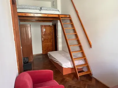 a room with a bunk bed and a ladder at Central cozy rooms Soukenická S34 in Prague