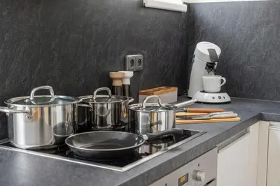 a kitchen counter with pots and pans on a stove at Sky Apartment Residence in Prague