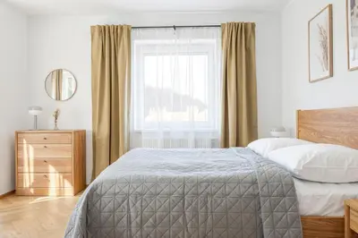 a bedroom with a bed and a window at Sky Apartment Residence in Prague