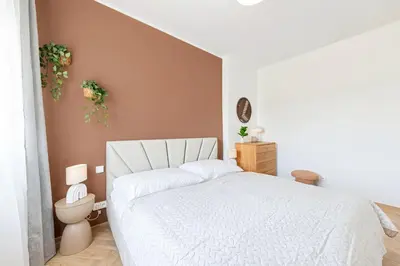 a bedroom with a white bed and a toilet at Sky Apartment Residence in Prague