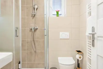 a bathroom with a shower with a toilet and a sink at Sky Panorama Villa in Prague
