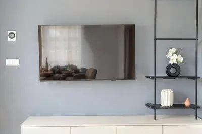 a living room with a mirror on the wall at Sky Panorama Villa in Prague