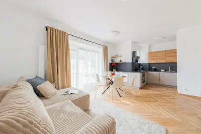 a white living room with a couch and a kitchen at Sky Panorama Villa in Prague