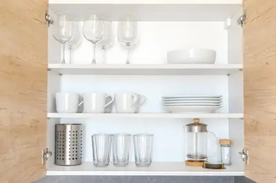 a cupboard with wine glasses and dishes on it at Sky Panorama Villa in Prague
