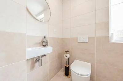 a bathroom with a toilet and a sink and a mirror at Sky Panorama Villa in Prague