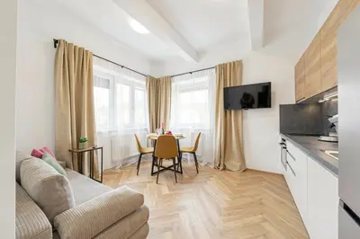 a living room with a couch and a table at Sky Panorama Villa in Prague