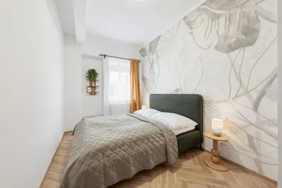 a bedroom with a bed and a wall mural at Sky Panorama Villa in Prague