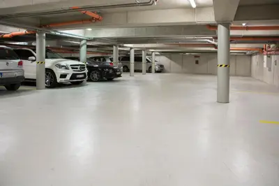 a large parking garage with cars parked in it at Limes Apartments in Prague