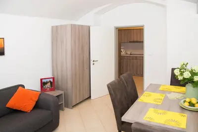 a living room with a table and a couch at Limes Apartments in Prague
