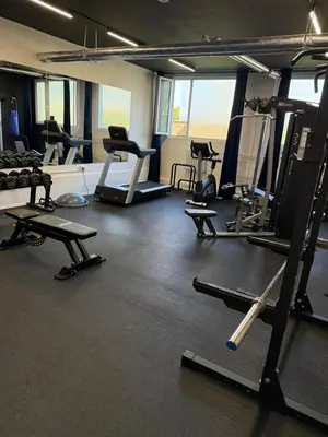 a gym with several treadmills and machines in it at ObriyPraha in Prague