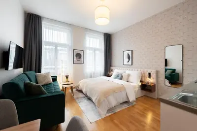 a bedroom with a bed and a couch and a sink at Harry Potters Magical Diagon Alley Stay in Prague in Prague