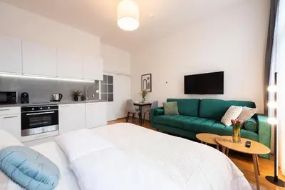 a living room with a bed and a green couch at Harry Potters Magical Diagon Alley Stay in Prague in Prague