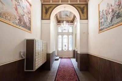 a hallway with a door with paintings on the walls at Harry Potters Magical Diagon Alley Stay in Prague in Prague