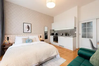a bedroom with a white bed and a green couch at Harry Potters Magical Diagon Alley Stay in Prague in Prague
