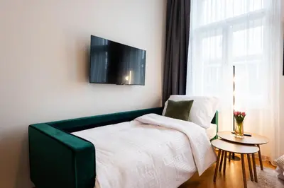 a bedroom with a bed and a tv on the wall at Harry Potters Magical Diagon Alley Stay in Prague in Prague