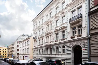 a large white building with cars parked in front of it at Harry Potters Magical Diagon Alley Stay in Prague in Prague