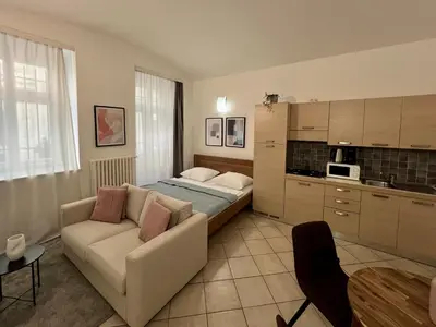 a living room with a couch and a kitchen at Opatovicka Central Living in Prague
