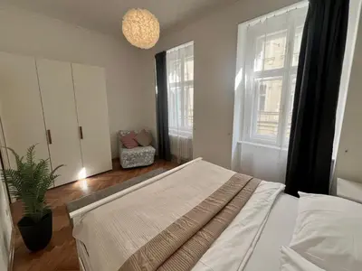 a bedroom with a bed and a potted plant at Opatovicka Central Living in Prague
