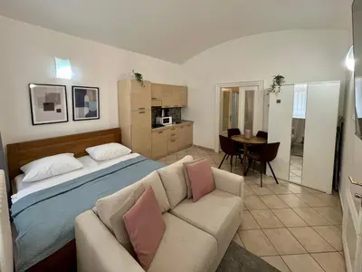 a bedroom with a bed and a couch at Opatovicka Central Living in Prague