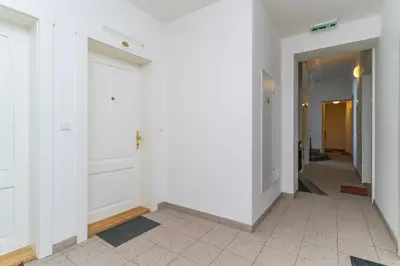 a hallway with white walls and white doors at Bright 1 BR, close to Malá Strana & Dancing House in Prague