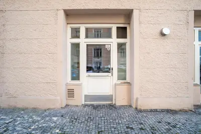 a white door of a building with a window at Bright 1 BR, close to Malá Strana & Dancing House in Prague