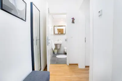 a white bathroom with a toilet and a sink at Bright 1 BR, close to Malá Strana & Dancing House in Prague