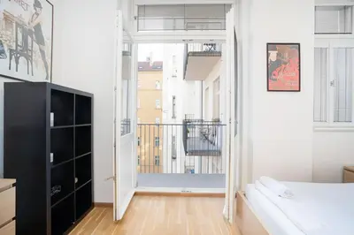 a bedroom with a bed and a balcony at Bright 1 BR, close to Malá Strana & Dancing House in Prague