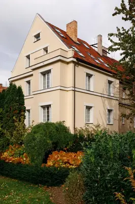 a large white house with a red roof at Guest House Villa Monet in Prague