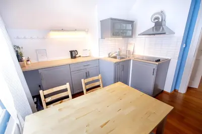 a kitchen with a wooden table and a table and chairs at Guest House Villa Monet in Prague
