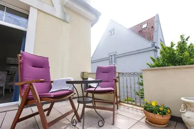 two purple chairs and a table on a balcony at Guest House Villa Monet in Prague