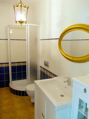 a bathroom with a toilet and a sink and a mirror at Guest House Villa Monet in Prague